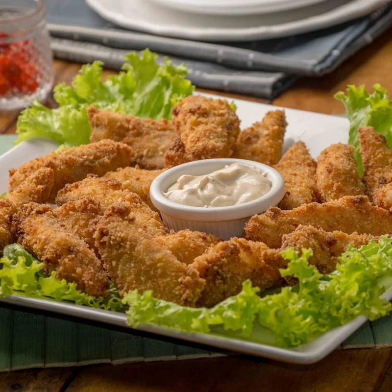 Dipping Nashville fried chicken tender